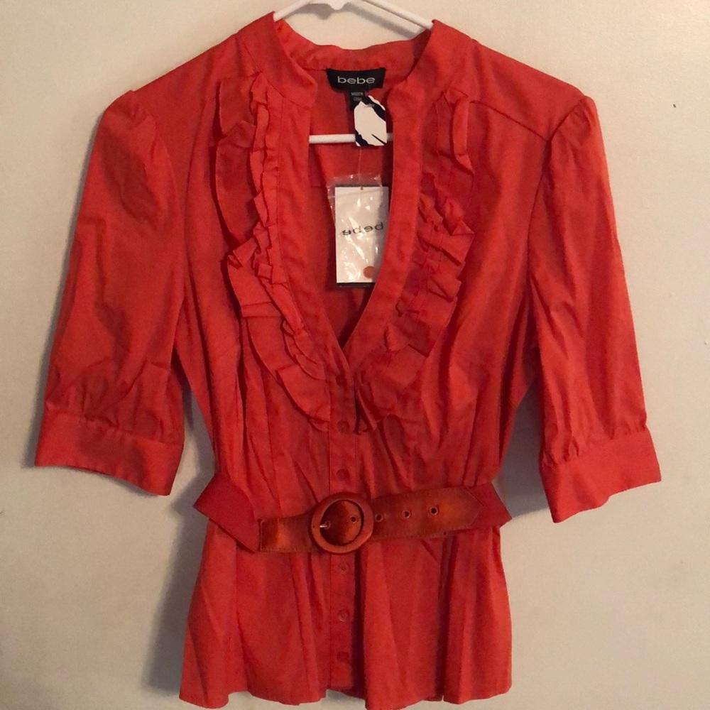Beautiful NWT bebe top. Ruffles on front & belted